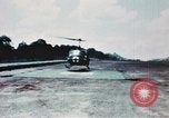 Image of medical aid via Huey helicopter and ambulance Vietnam, 1966, second 30 stock footage video 65675077440