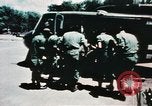 Image of medical aid via Huey helicopter and ambulance Vietnam, 1966, second 41 stock footage video 65675077440