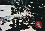Image of medical aid via Huey helicopter and ambulance Vietnam, 1966, second 44 stock footage video 65675077440