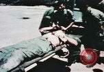 Image of medical aid via Huey helicopter and ambulance Vietnam, 1966, second 45 stock footage video 65675077440