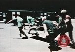 Image of medical aid via Huey helicopter and ambulance Vietnam, 1966, second 61 stock footage video 65675077440