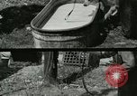 Image of worker washes a dog on Circus camp ground United States USA, 1919, second 3 stock footage video 65675078135