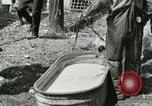 Image of worker washes a dog on Circus camp ground United States USA, 1919, second 6 stock footage video 65675078135