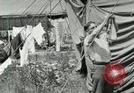 Image of worker washes a dog on Circus camp ground United States USA, 1919, second 33 stock footage video 65675078135