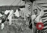 Image of worker washes a dog on Circus camp ground United States USA, 1919, second 38 stock footage video 65675078135