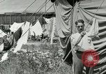 Image of worker washes a dog on Circus camp ground United States USA, 1919, second 40 stock footage video 65675078135