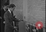 Image of Young men and women punch  time clock at Ford facility Dearborn Michigan  USA, 1938, second 46 stock footage video 65675078259
