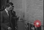 Image of Young men and women punch  time clock at Ford facility Dearborn Michigan  USA, 1938, second 47 stock footage video 65675078259