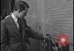 Image of Young men and women punch  time clock at Ford facility Dearborn Michigan  USA, 1938, second 48 stock footage video 65675078259