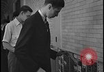 Image of Young men and women punch  time clock at Ford facility Dearborn Michigan  USA, 1938, second 50 stock footage video 65675078259