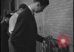 Image of Young men and women punch  time clock at Ford facility Dearborn Michigan  USA, 1938, second 51 stock footage video 65675078259