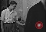 Image of Young men and women punch  time clock at Ford facility Dearborn Michigan  USA, 1938, second 52 stock footage video 65675078259
