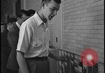 Image of Young men and women punch  time clock at Ford facility Dearborn Michigan  USA, 1938, second 53 stock footage video 65675078259