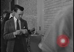 Image of Young men and women punch  time clock at Ford facility Dearborn Michigan  USA, 1938, second 54 stock footage video 65675078259