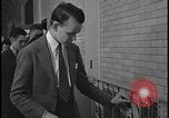 Image of Young men and women punch  time clock at Ford facility Dearborn Michigan  USA, 1938, second 55 stock footage video 65675078259