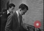 Image of Young men and women punch  time clock at Ford facility Dearborn Michigan  USA, 1938, second 56 stock footage video 65675078259