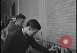 Image of Young men and women punch  time clock at Ford facility Dearborn Michigan  USA, 1938, second 59 stock footage video 65675078259