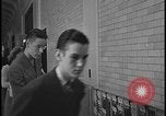 Image of Young men and women punch  time clock at Ford facility Dearborn Michigan  USA, 1938, second 60 stock footage video 65675078259