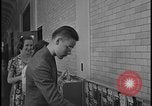Image of Young men and women punch  time clock at Ford facility Dearborn Michigan  USA, 1938, second 61 stock footage video 65675078259