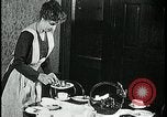 Image of woman with apron clearing plates Kansas City Missouri USA, 1922, second 35 stock footage video 65675078311