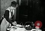 Image of woman with apron clearing plates Kansas City Missouri USA, 1922, second 39 stock footage video 65675078311