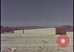 Image of atomic bomb test blast destroying buildings Nevada United States USA, 1955, second 14 stock footage video 65675078373
