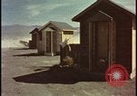 Image of atomic bomb shock wave hits huts Nevada United States USA, 1955, second 1 stock footage video 65675078378