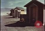 Image of atomic bomb shock wave hits huts Nevada United States USA, 1955, second 3 stock footage video 65675078378