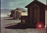 Image of atomic bomb shock wave hits huts Nevada United States USA, 1955, second 6 stock footage video 65675078378