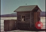 Image of atomic bomb shock wave hits huts Nevada United States USA, 1955, second 10 stock footage video 65675078378