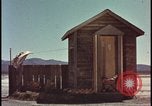 Image of atomic bomb shock wave hits huts Nevada United States USA, 1955, second 17 stock footage video 65675078378