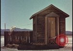 Image of atomic bomb shock wave hits huts Nevada United States USA, 1955, second 18 stock footage video 65675078378