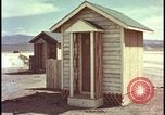 Image of atomic bomb shock wave hits huts Nevada United States USA, 1955, second 23 stock footage video 65675078378