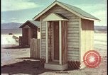 Image of atomic bomb shock wave hits huts Nevada United States USA, 1955, second 24 stock footage video 65675078378