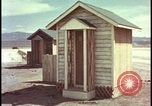 Image of atomic bomb shock wave hits huts Nevada United States USA, 1955, second 25 stock footage video 65675078378