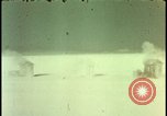 Image of atomic bomb shock wave hits huts Nevada United States USA, 1955, second 27 stock footage video 65675078378