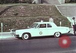 Image of police car rural road United States USA, 1964, second 39 stock footage video 65675078748