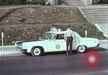 Image of police car rural road United States USA, 1964, second 42 stock footage video 65675078748