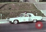 Image of police car rural road United States USA, 1964, second 44 stock footage video 65675078748