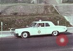 Image of police car rural road United States USA, 1964, second 46 stock footage video 65675078748