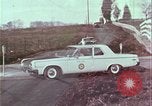 Image of police car rural road United States USA, 1964, second 47 stock footage video 65675078748