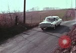 Image of police car rural road United States USA, 1964, second 49 stock footage video 65675078748