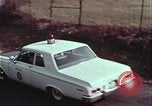 Image of police car rural road United States USA, 1964, second 52 stock footage video 65675078748