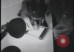 Image of FBI technicians view forensic evidence with microscopes United States USA, 1959, second 9 stock footage video 65675078761