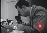 Image of FBI technicians view forensic evidence with microscopes United States USA, 1959, second 11 stock footage video 65675078761