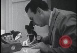 Image of FBI technicians view forensic evidence with microscopes United States USA, 1959, second 13 stock footage video 65675078761