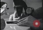 Image of FBI technicians view forensic evidence with microscopes United States USA, 1959, second 15 stock footage video 65675078761