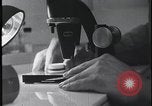 Image of FBI technicians view forensic evidence with microscopes United States USA, 1959, second 16 stock footage video 65675078761