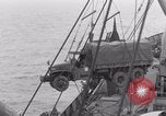 Image of truck lifted to landing craft WW2 France, 1944, second 49 stock footage video 65675079352