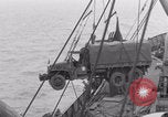 Image of truck lifted to landing craft WW2 France, 1944, second 50 stock footage video 65675079352